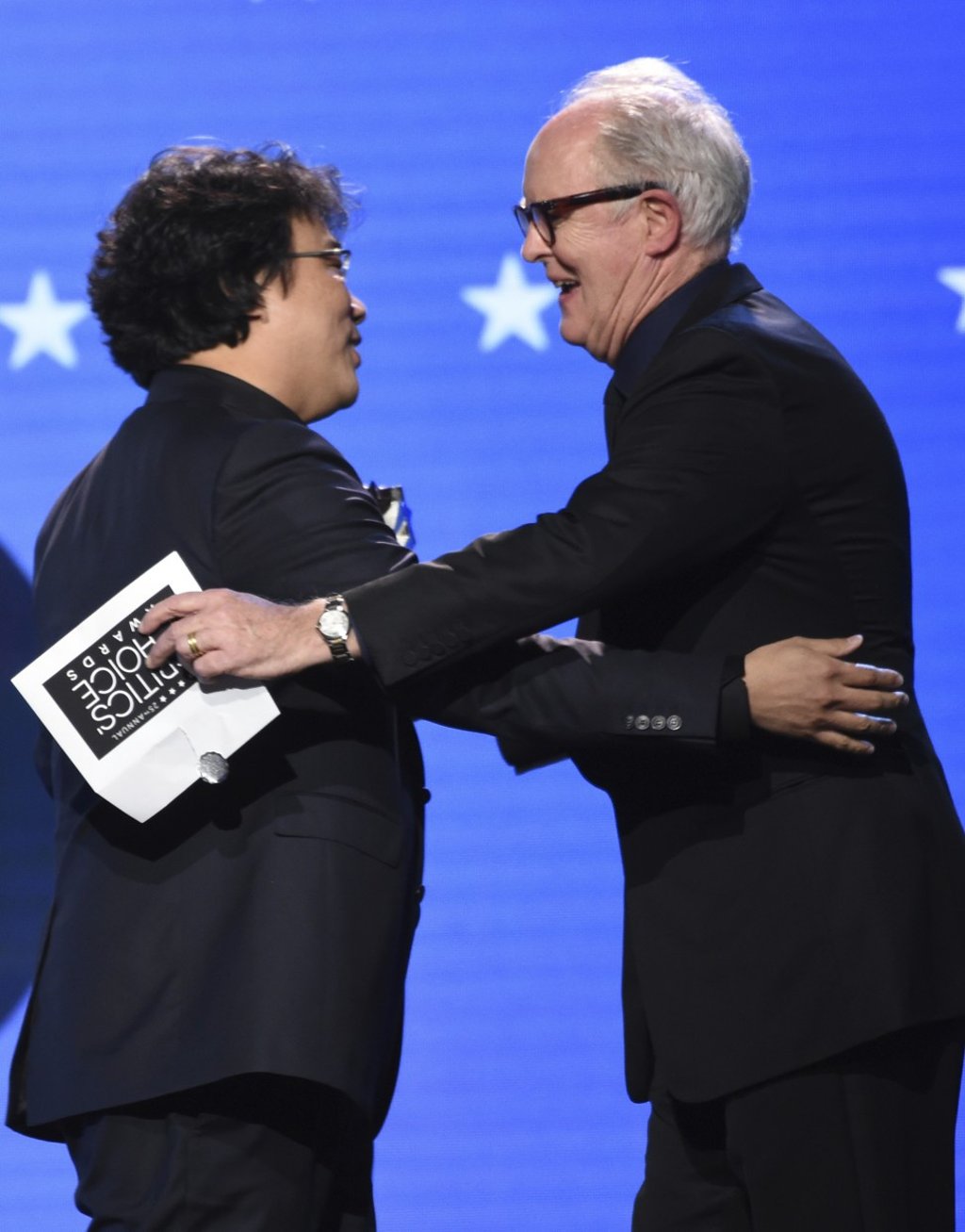 John Lithgow, right, presents the award for best director to Bong Joon-ho for Parasite, at the 25th annual Critics' Choice Awards. Photo: AP Photo