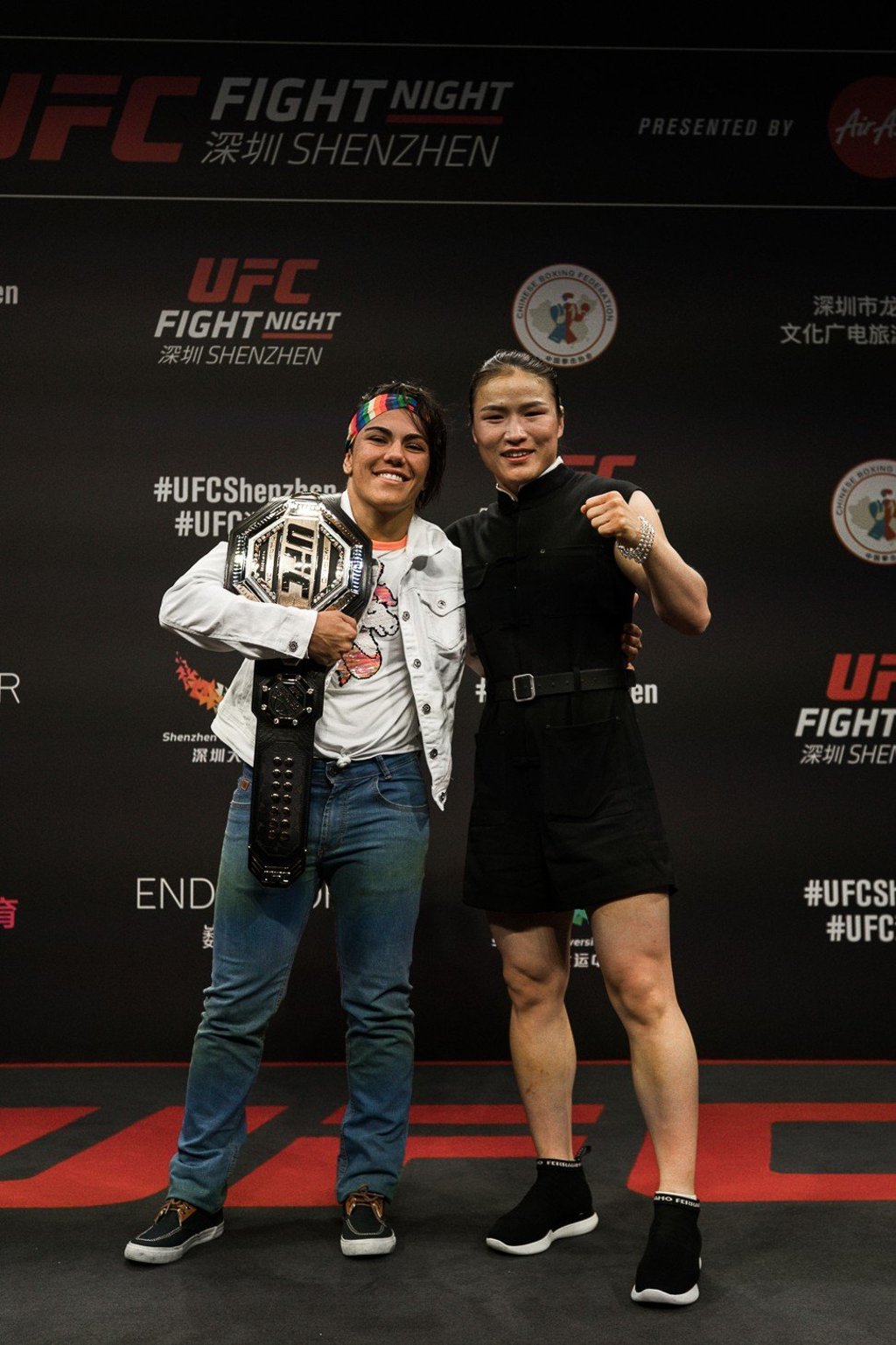 UFC strawweight champion Jéssica Andrade (with belt) and Zhang Weili pose before their title fight in Shenzhen on August 31.