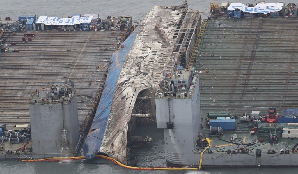 The sunken ferry Sewol is lifted from the water and transported back to land in 2017. Photo: AP