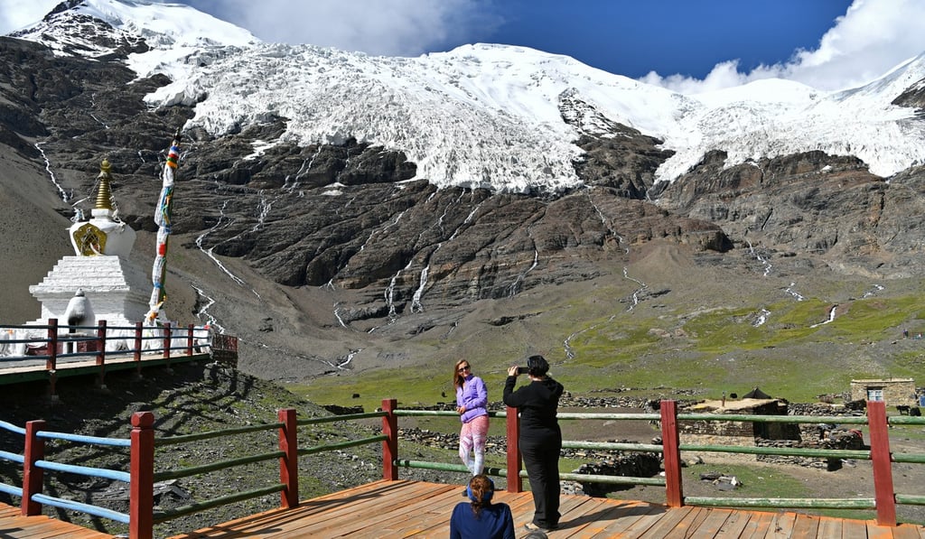 A tourist poses for photos at the Karuola Glacier scenic area in southwest China's Tibet autonomous region. China says the region is open to all foreigners, but the US found that Beijing has “systematically impeded travel” for diplomats and journalists. Photo: Xinhua
