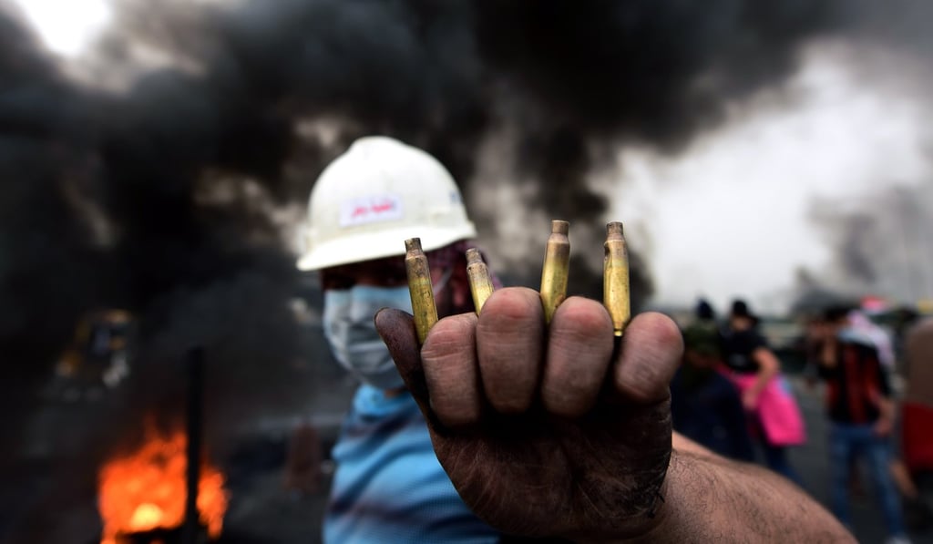 An Iraqi protester shows used bullet cartridges fired by Iraqi security forces during a strike and anti-government demonstrations in Baghdad, Iraq. Photo: EPA-EFE An Iraqi protester shows used bullet cartridges fired by Iraqi security forces during a strike and anti-government demonstrations in Baghdad, Iraq. Photo: EPA-EFE
