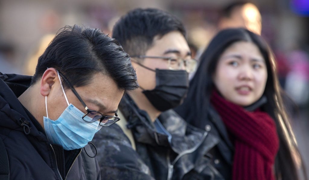 Travellers wear face masks. Photo: AP Photo Travellers wear face masks. Photo: AP Photo