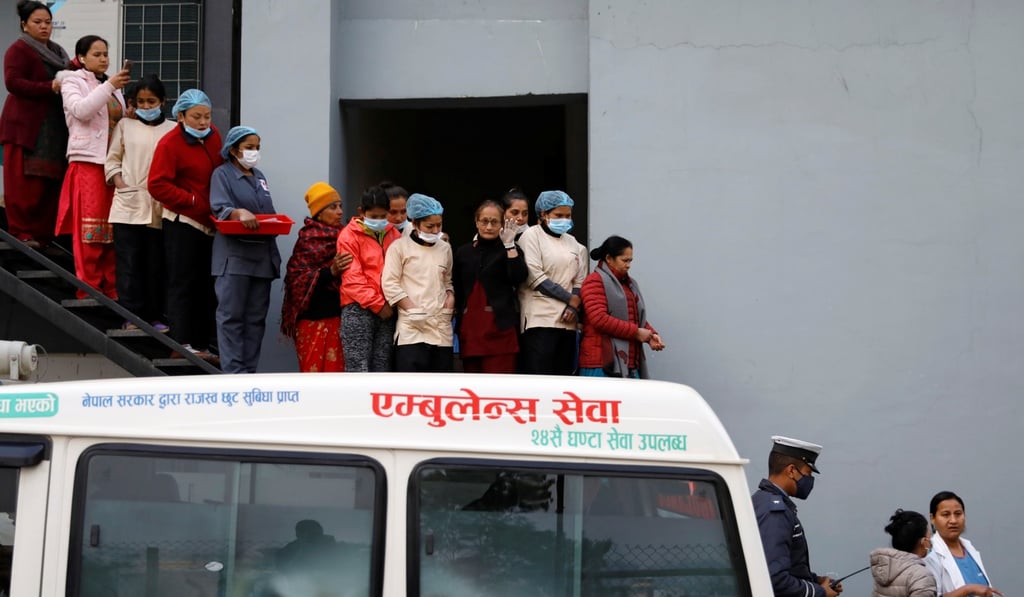 Hospital staff observe as the bodies of eight Indian tourists who died due to suspected suffocation are carried inside an ambulance. Photo: Reuters