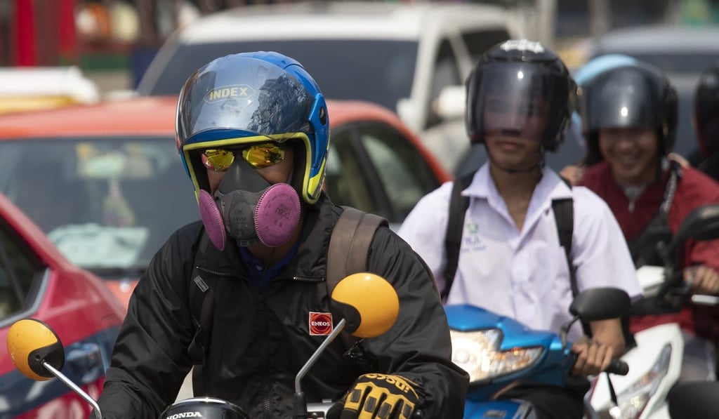 Motorcyclists wear face masks to protect from the poor air quality in Bangkok. Photo: AP