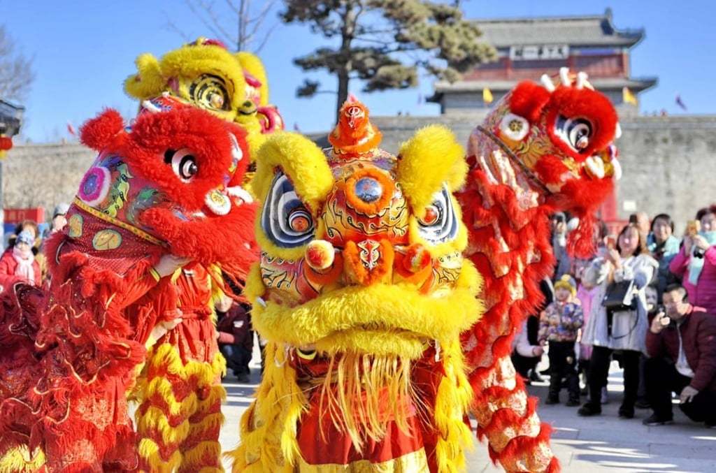 Artists perform lion dance at the Shanhaiguan Pass, a famous tourist resort in Qinhuangdao City, north China's Hebei Province, marking Lunar New Year in 2019. Photo: Xinhua