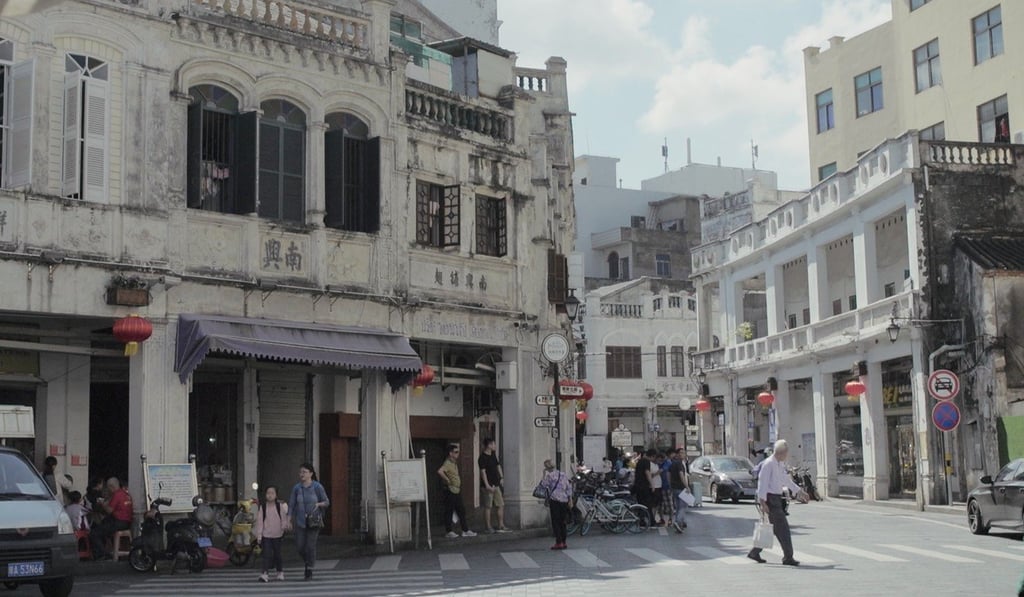 The historic balcony-style tenement buildings of Haikou’s Qilou Old Street, on the Chinese resort island of Hainan, feature ground-floor shops and multistorey residential floors above.
