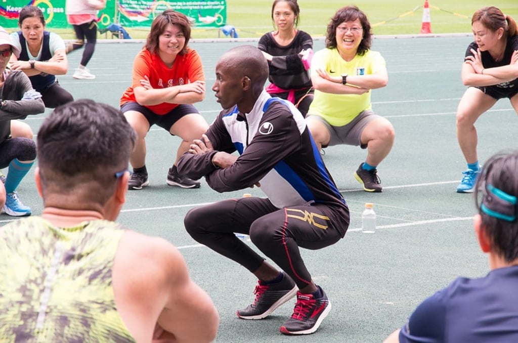 Kenyan long distance runner Lukas Wambua Muteti puts participants through their paces at a training workshop in Hong Kong. Photo: CAMEXPASIA