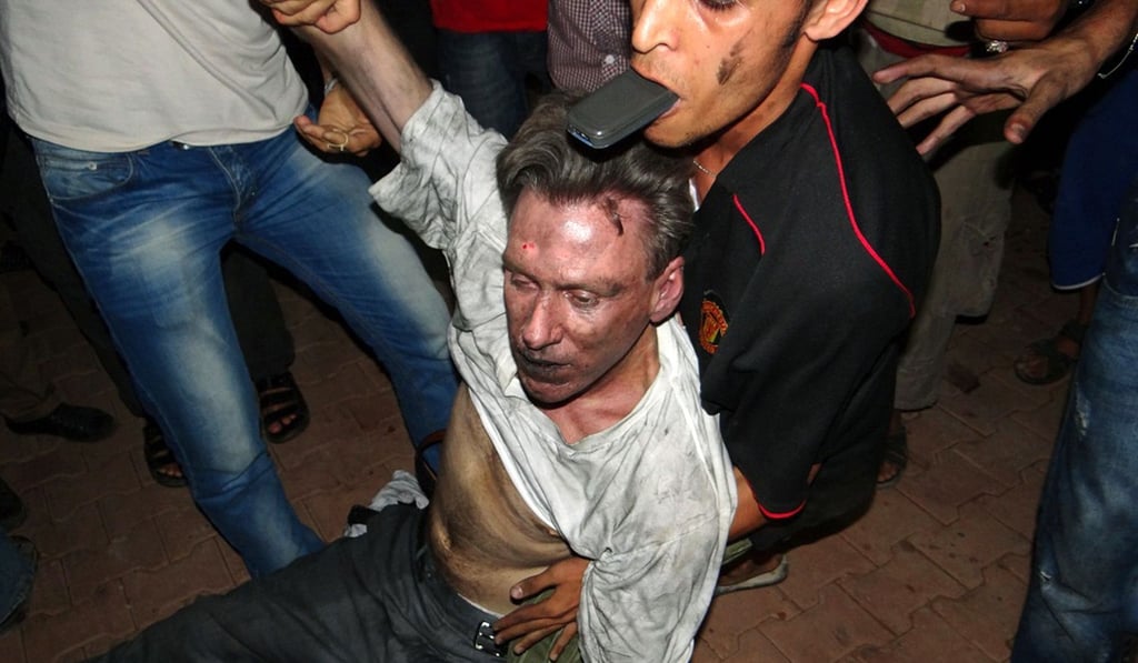 The body of US ambassador to Libya, Chris Stevens, being moved by civilians following the overnight attack on the embassy. Photo: AFP