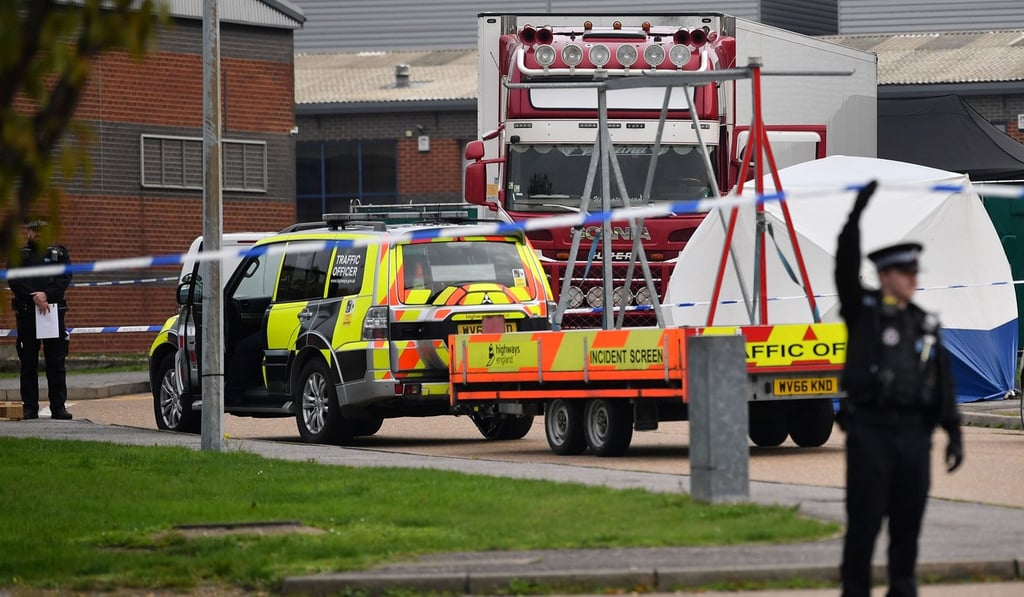 British Police officers work near a truck, believed to have originated from Bulgaria and containing 39 dead bodies, discovered at Waterglade Industrial Park in Grays, east of London, on October 23. Photo: AFP