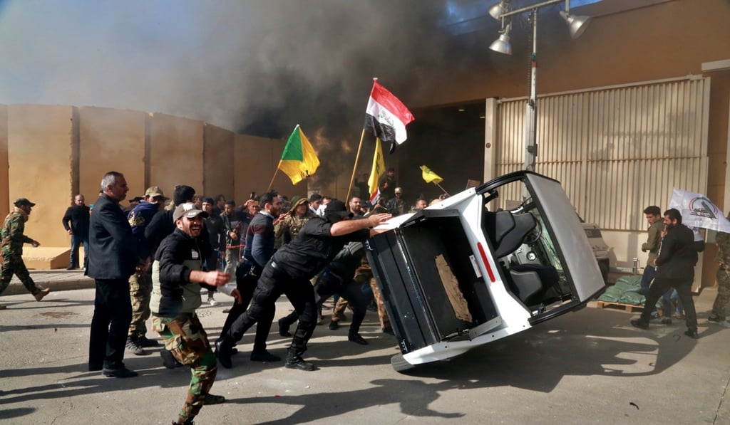 Protesters damage property inside the US embassy compound, in Baghdad in December 2019. Photo: AP Photo