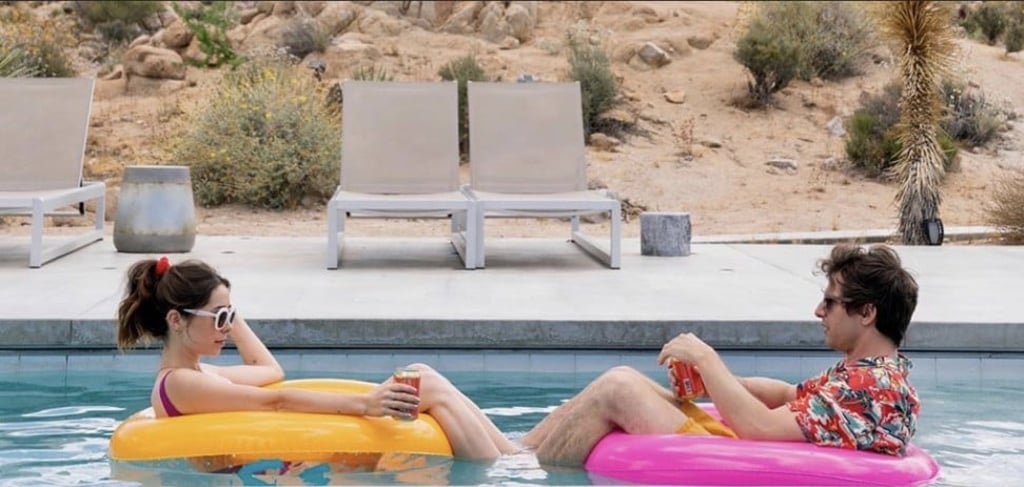 Andy Samberg and Cristin Milioti in a still from Palm Springs (2020). Andy Samberg and Cristin Milioti in a still from Palm Springs (2020).