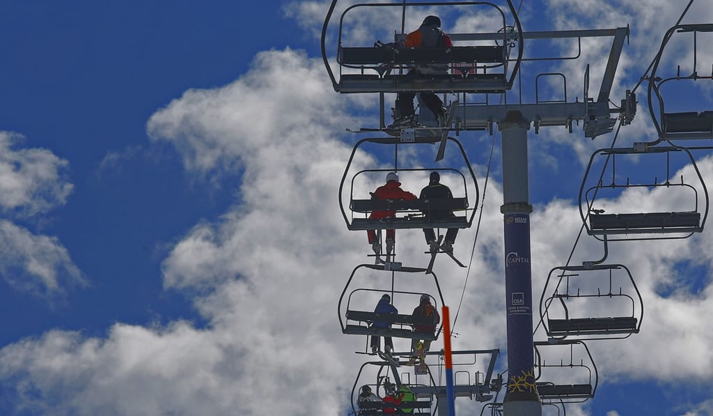 Tourists ride a ski lift at a winter resort. Photo: Xinhua