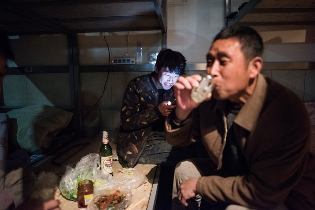 A man drinks alcohol in a dormitory in Beijing. Photo: AFP A man drinks alcohol in a dormitory in Beijing. Photo: AFP