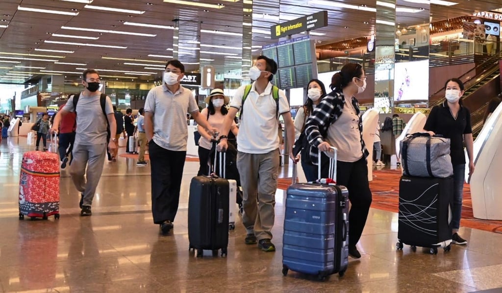 Travellers seen in protective face masks at the departure hall of Changi Airport in Singapore on January 30, 2020. Photo: AFP