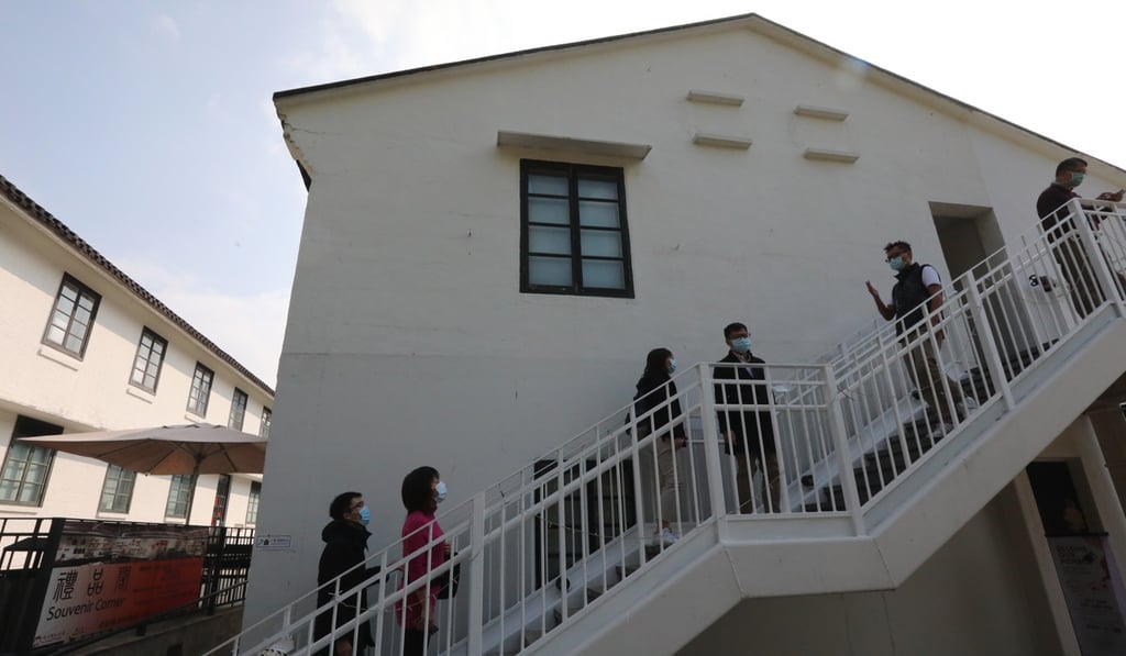 Guests leave the Heritage Lodge in Lai Chi Kok after it was designated as a coronavirus quarantine site by the government. Photo: Felix Wong