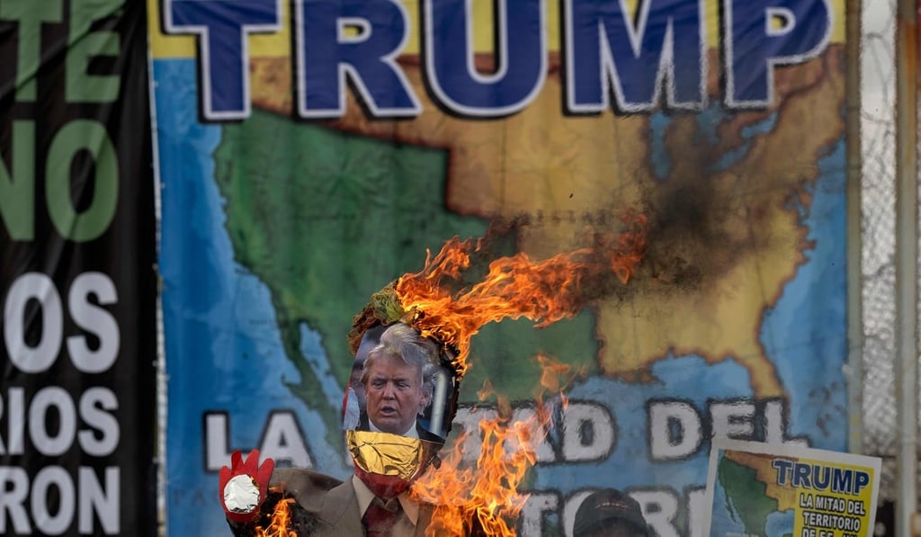 A piñata depicting US President Donald Trump is burned by members of Border Angels and Alianza Migrante (Migrant Alliance) during a demonstration at the US-Mexico border. Photo: AFP A piñata depicting US President Donald Trump is burned by members of Border Angels and Alianza Migrante (Migrant Alliance) during a demonstration at the US-Mexico border. Photo: AFP
