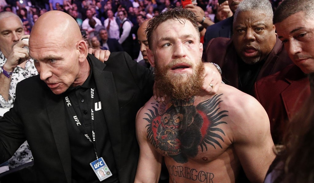 McGregor is escorted from the cage area after losing to Khabib at UFC 229 in Las Vegas. Photo: AP