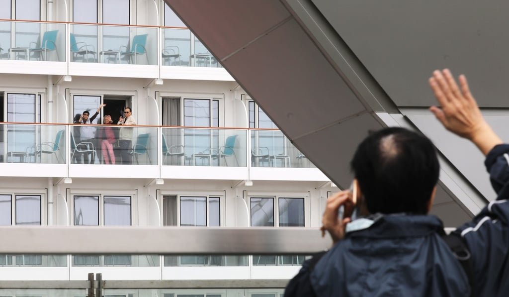 Passengers on board the World Dream wave to family member on shore. Photo: Dickson Lee