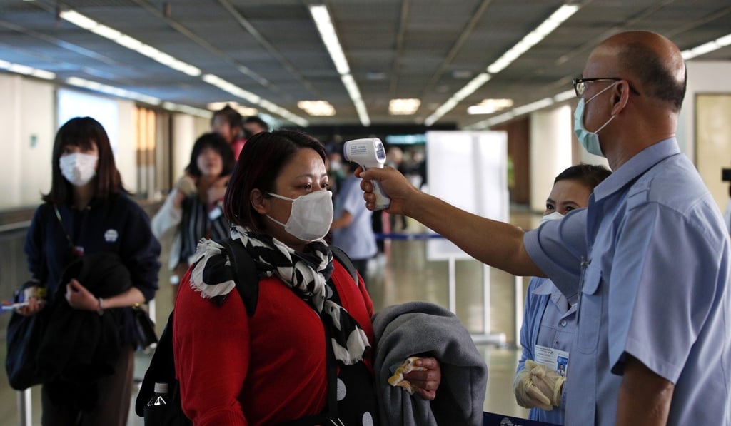 Thai health officials check the temperature of arriving passengers at Don Mueang Airport in Bangkok on February 7, 2020. Photo: EPA-EFE Thai health officials check the temperature of arriving passengers at Don Mueang Airport in Bangkok on February 7, 2020. Photo: EPA-EFE