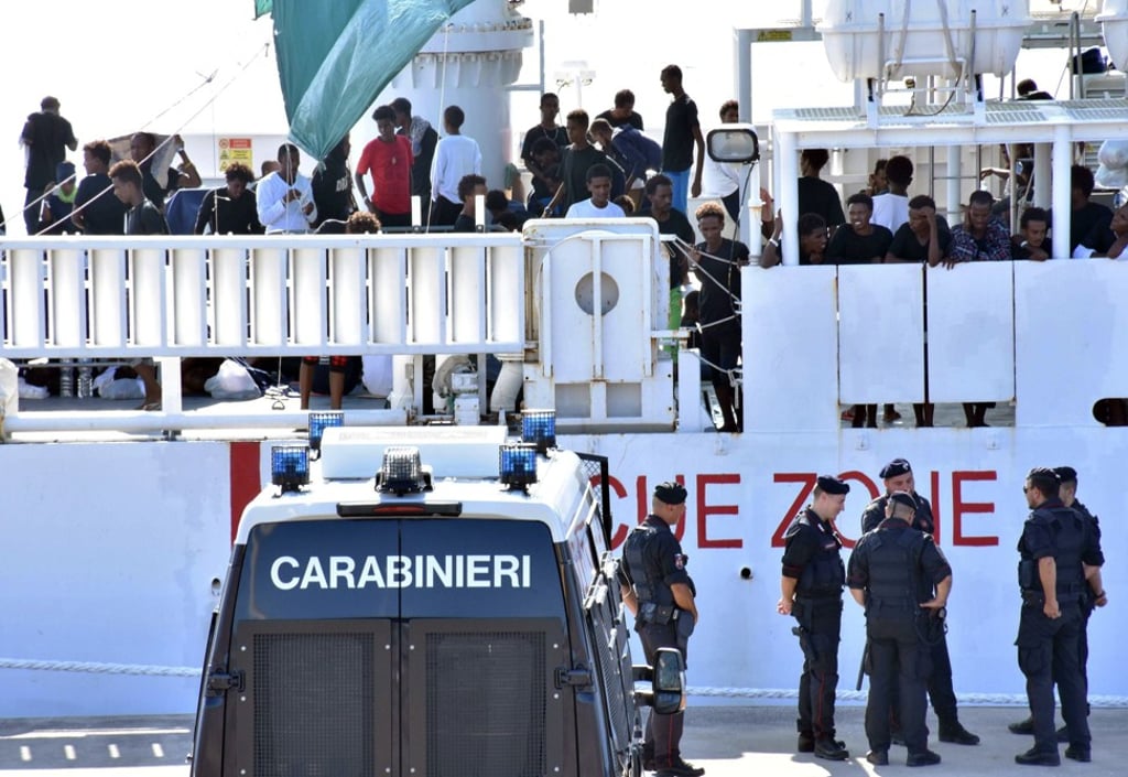 Italian law enforcement officers at the port of Catania in August 2018 wait for information on whether to allow a group of 177 migrants to disembark from a coastguard vessel. Photo: EPA-EFE