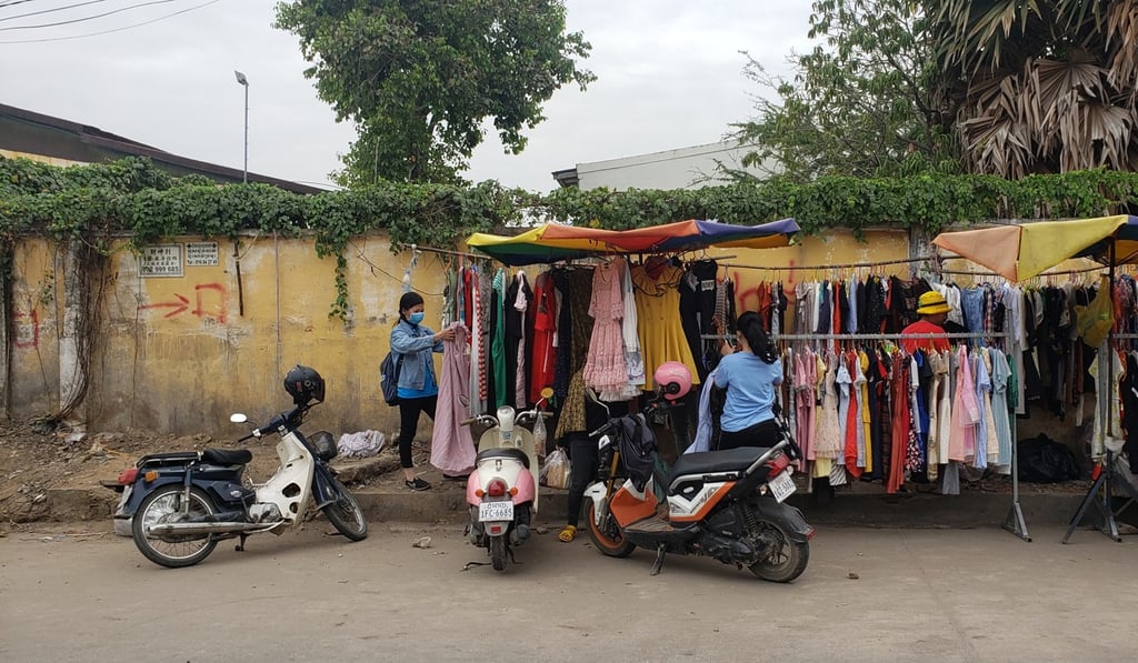 Workers shop for clothes at a street stall outside the closed Zhong Hua Printing Company in Phnom Penh's Tuol Sangke commune on Tuesday. Photo: Danielle Keeton-Olsen Workers shop for clothes at a street stall outside the closed Zhong Hua Printing Company in Phnom Penh's Tuol Sangke commune on Tuesday. Photo: Danielle Keeton-Olsen