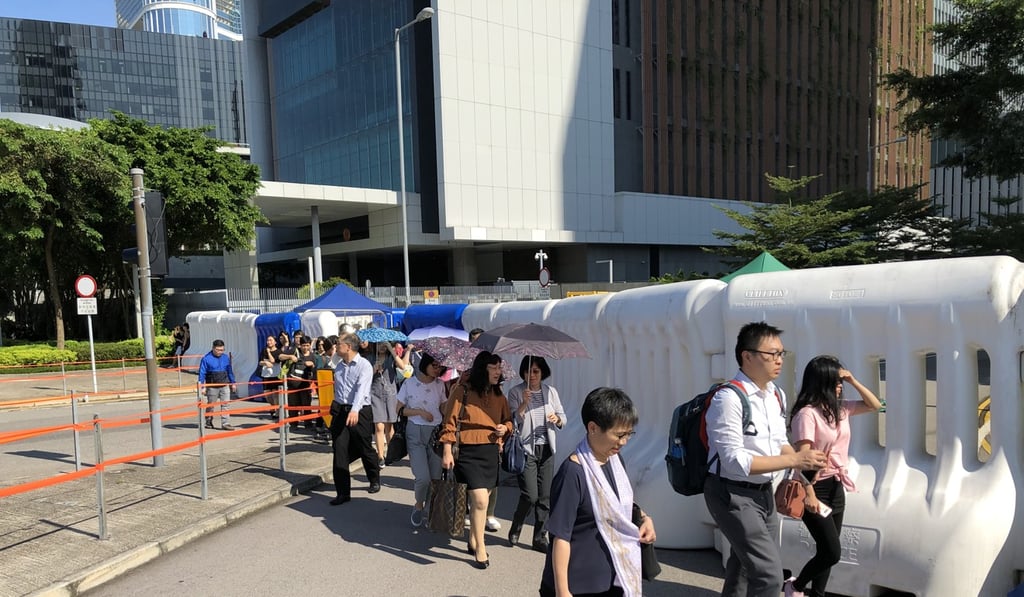Civil servants leave government headquarters in Admiralty on August 5. The coronavirus outbreak has made working from home a regular practice for many civil servants. Photo: Alvin Lum