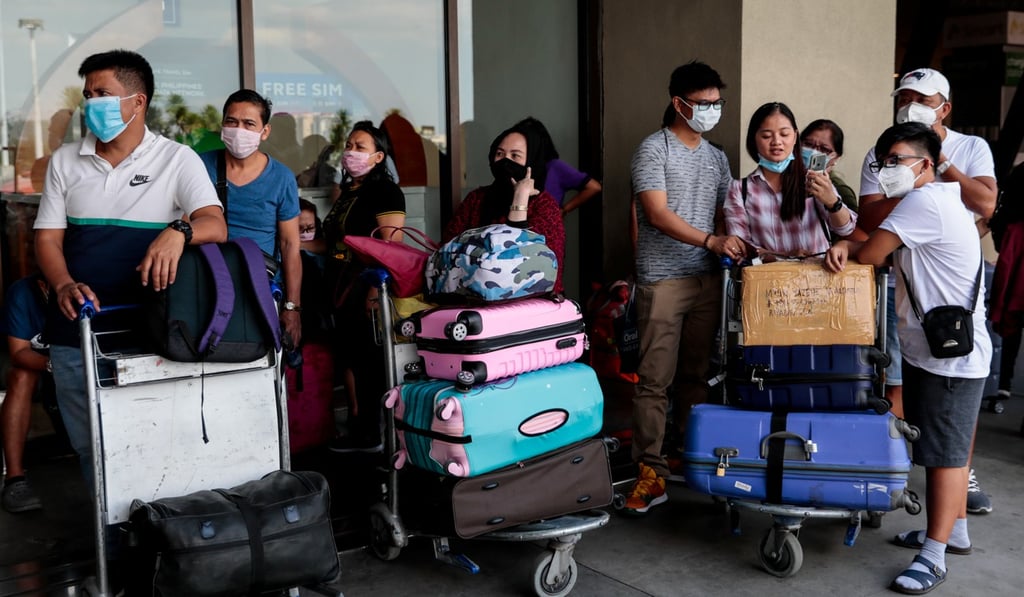 Passengers with protective masks seen at the departure area at Ninoy Aquino International Airport in Manila. Photo: Reuters