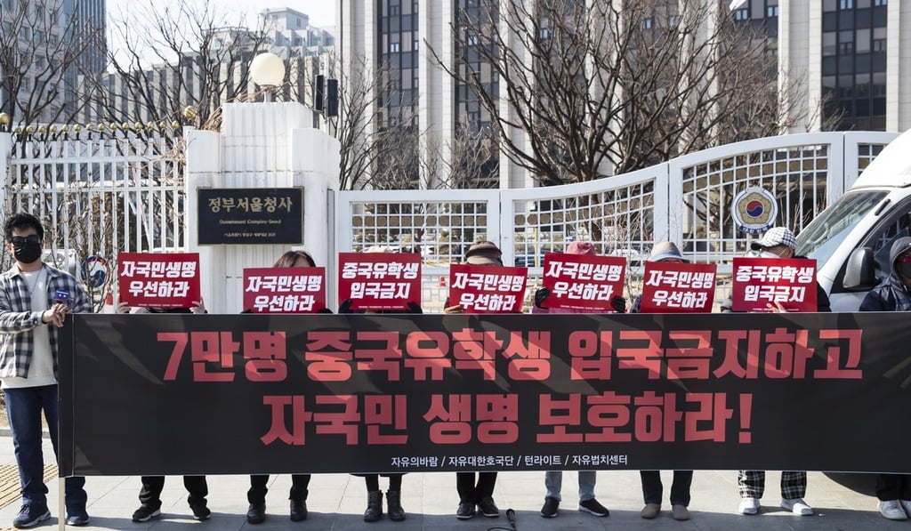 Activists in South Korea at a protest on Tuesday demanding the government prevent Chinese students from returning to the country over fears of the outbreak. Photo: EPA