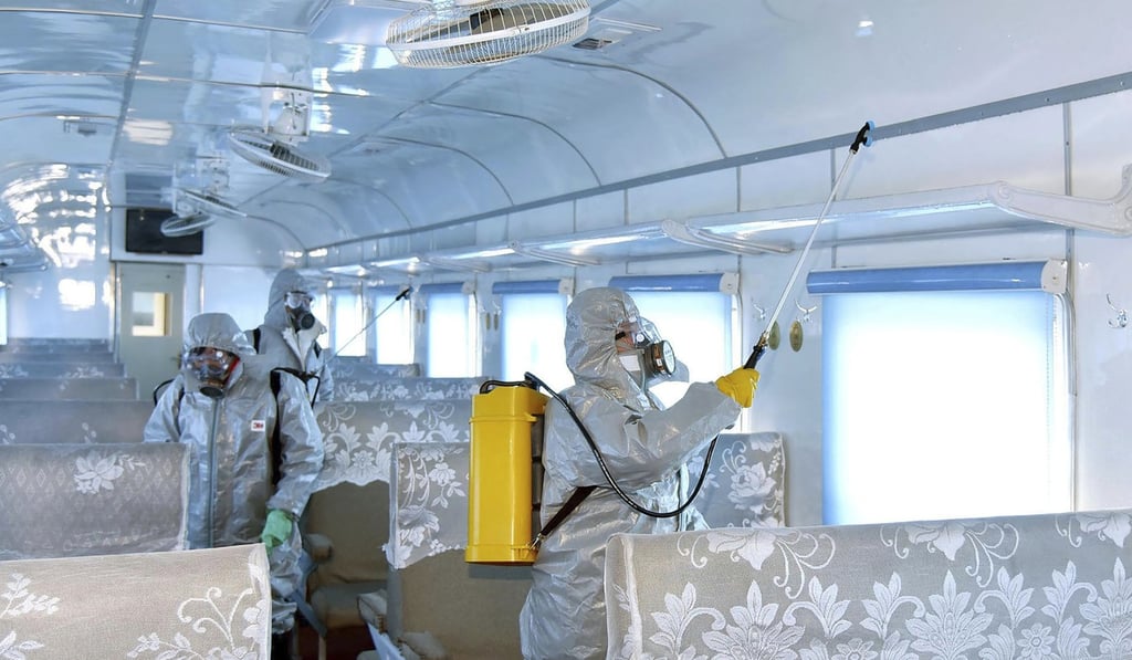 North Korean workers in protective suits disinfect a facility against a new virus at an undisclosed place in North Korea. Photo: AP