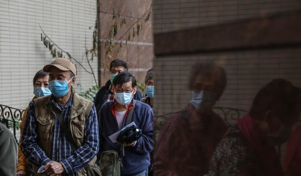 Elderly citizens queue for free surgical masks distributed by the Democratic Party in Yau Ma Tei. Photo: Sam Tsang