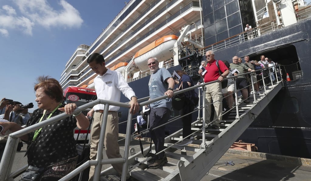 Passengers of the Westerdam disembark on February 15, 2020. Photo: AP Passengers of the Westerdam disembark on February 15, 2020. Photo: AP