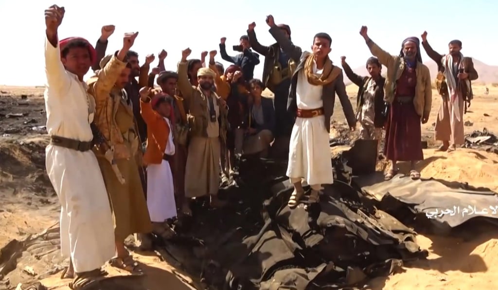 Yemenis cheering at the site of the downing of a Saudi Tornado aircraft following an air strike by Iran-backed Houthi rebels in Yemen's northern Al-Jawf province. Photo: Handout via AFP