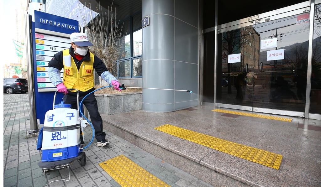 An official disinfects the entrance to a church in Daegu, amid fears over the spread of the new coronavirus. Photo: DPA