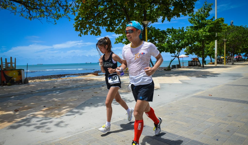 Nicole Chik runs with her father.
