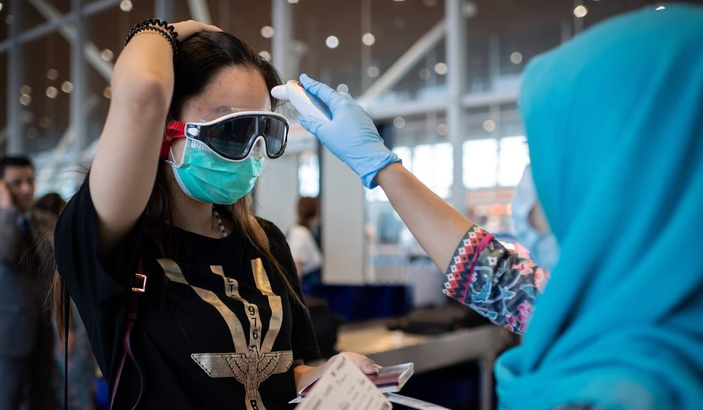 A Malaysia Airlines hostess checks the temperature of a Chinese passenger before she boards a flight to Beijing from Kuala Lumpur on Friday. Photo: AFP A Malaysia Airlines hostess checks the temperature of a Chinese passenger before she boards a flight to Beijing from Kuala Lumpur on Friday. Photo: AFP