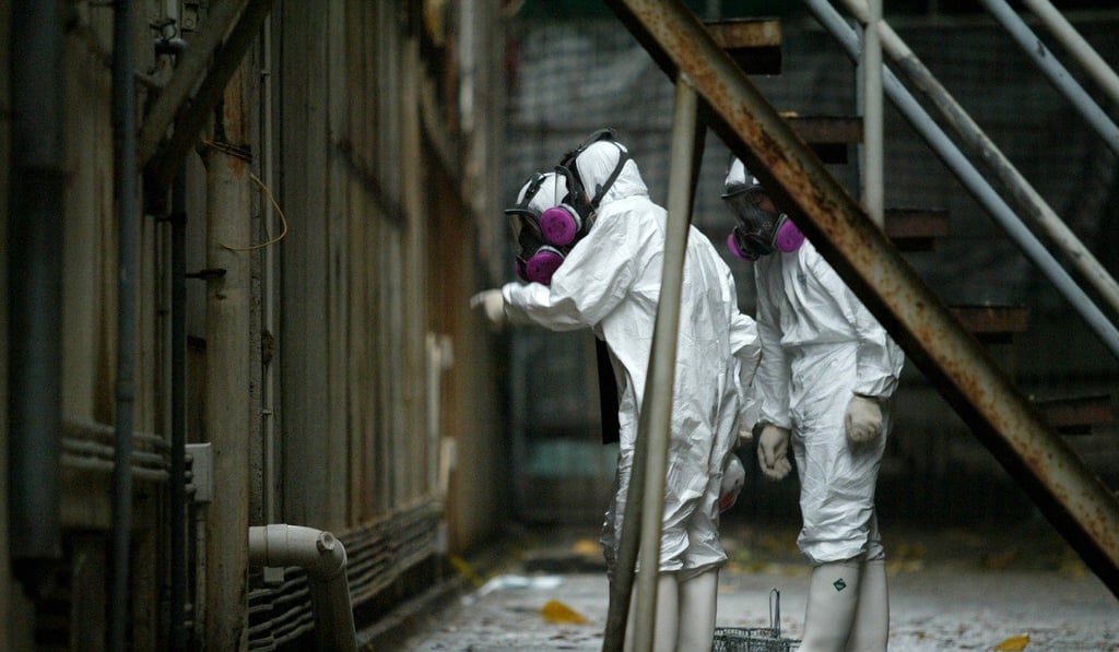 Officers in protective suits visit Amoy Gardens in 2003, where Sars was feared to have spread via the building’s pipes. Sewage design changes were subsequently suggested though never given the force of law. Photo: SCMP