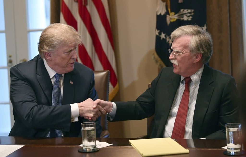 Bolton shakes hands with Trump at the start of a meeting with military leaders in April 2018. Photo: AP