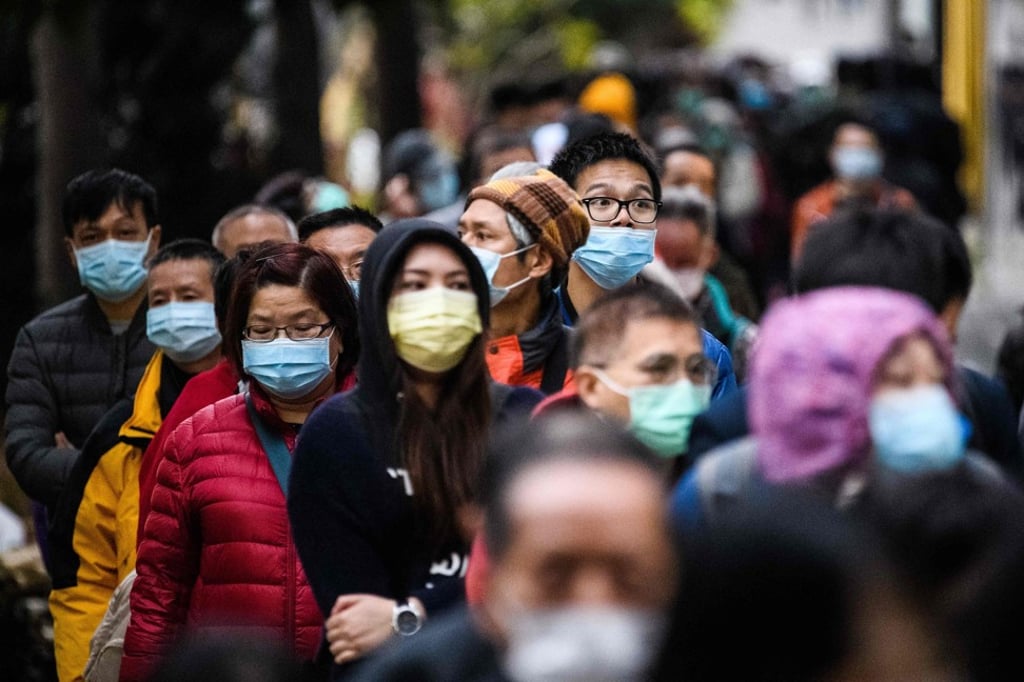 People wear facemasks as a preventative measure against the coronavirus, in Hong Kong, on February 5. Photo: AFP