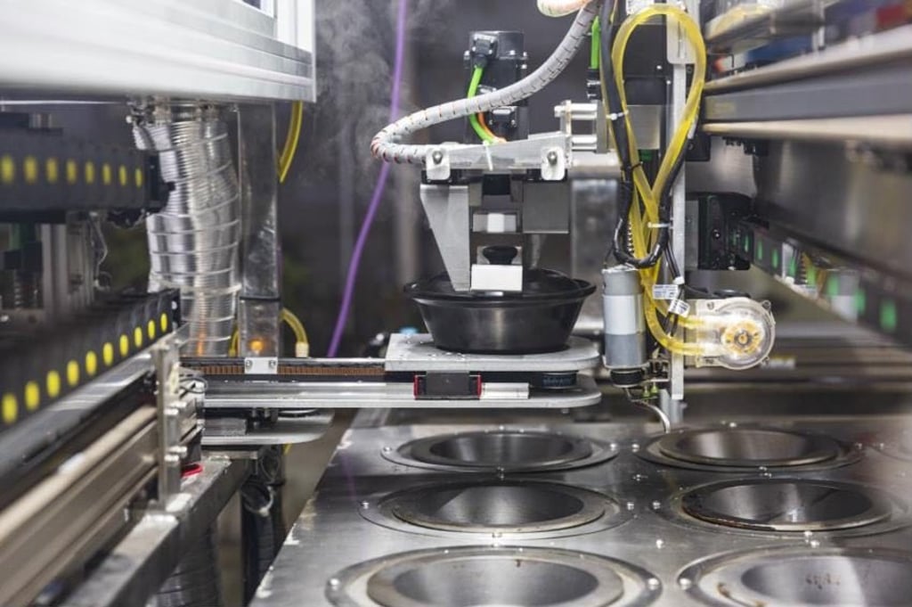 A robot chef preparing clay pot rice at a quarantine centre in the Hubei provincial capital of Wuhan. Photo: Handout by Country Garden Holdings