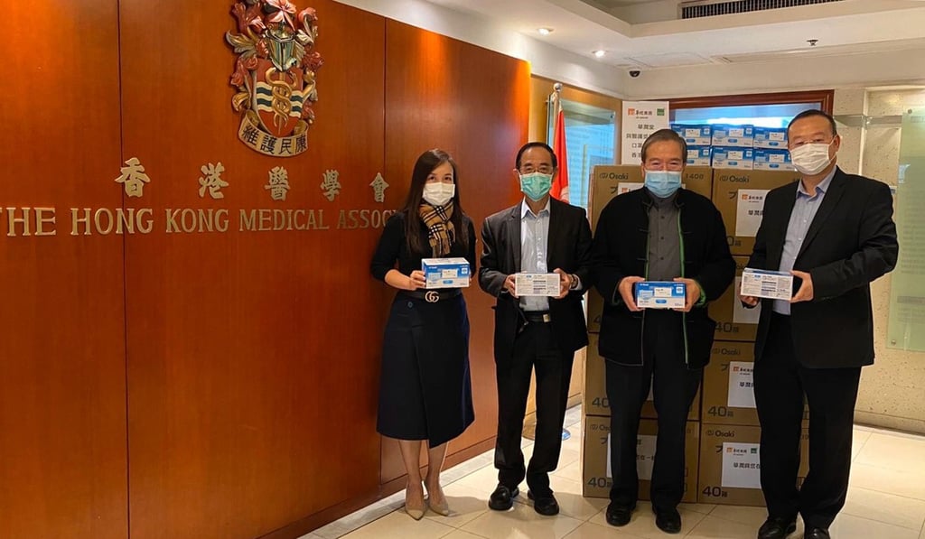 China Resources Medical Holdings Group chairman Anthony Wu (second right) presents a donation of 15,000 masks to the HK Medical Association. Photo: SCMP