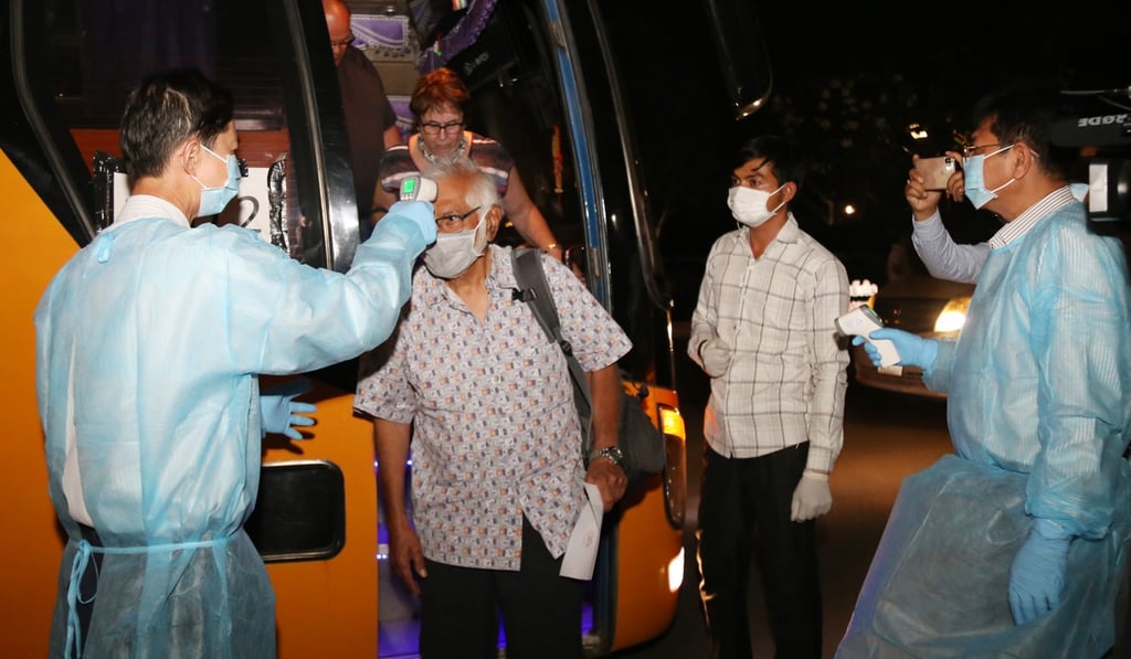 Cambodian health officials check the body temperature of Westerdam cruise ship passengers in Phnom Penh on Wednesday. Photo: Xinhua