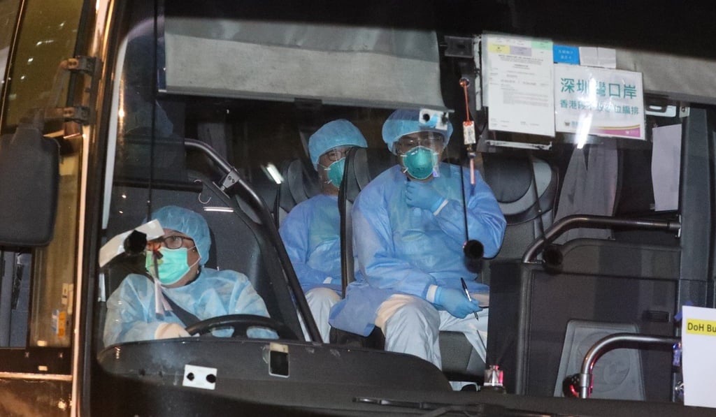 Staff helping to take the Diamond Princess’ Hong Kong passengers to quarantine are seen in a bus driving to the Chun Yeung Estate, Fo Tan, on Saturday. Photo: Felix Wong