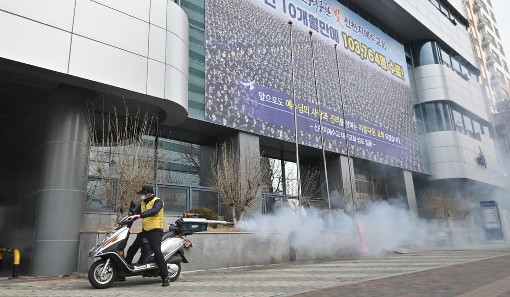A South Korean health official sprays disinfectant in front of the Daegu branch of the Shincheonji Church of Jesus. Photo: AFP A South Korean health official sprays disinfectant in front of the Daegu branch of the Shincheonji Church of Jesus. Photo: AFP