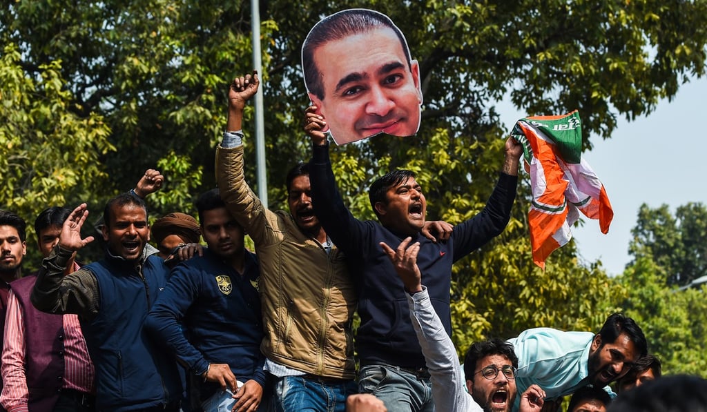Supporters of the Congress party shout slogans against billionaire jeweller Nirav Modi during a protest in New Delhi on February 16, 2018. Photo: Chandan Khanna/AFP