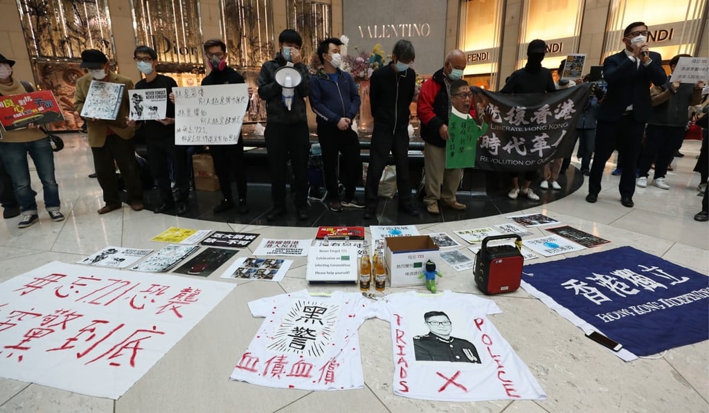 Anti-government protesters place beer on the ground to celebrate the news that a police officer had been infected by the coronavirus, during a rally in Central on February 21. Photo: Xiaomei Chen