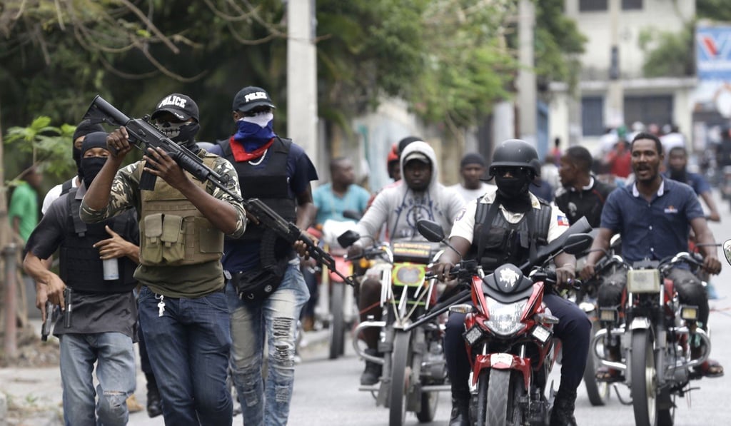 Armed off-duty police officers protest over pay and working conditions, in Port-au-Prince. Photo: AP