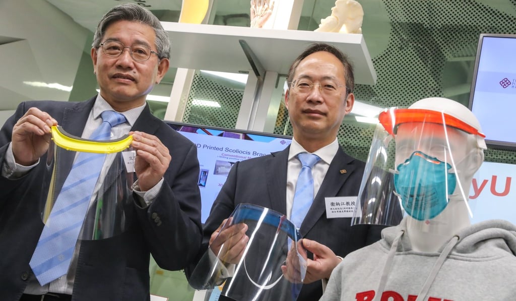 PolyU’s Man Hau-chung and Alexander Wai display the 3D-printed shields on Monday. K.Y. Cheng
