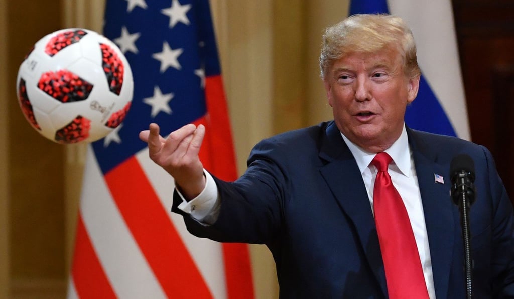 US President Donald Trump tosses a soccer ball he received as a gift from Russia's President Vladimir Putin during a joint press conference in the Presidential Palace in Helsinki in July 2018. Photo: AFP