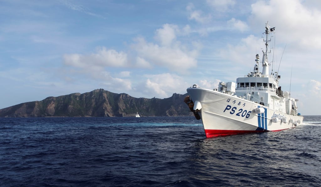 A Japan Coast Guard vessel sails in front of one of the disputed islands, named Senkaku in Japan and Diaoyu in China. Photo: Reuters