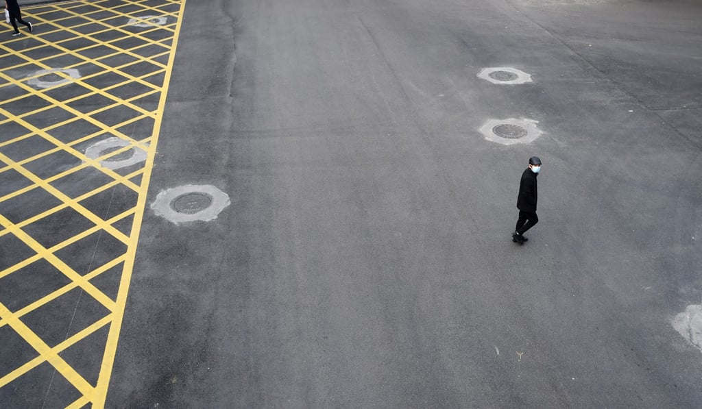 A man wearing a face mask crosses an empty road in Wuhan, epicentre of the novel coronavirus outbreak, where hundreds of Hongkongers are now stranded. Photo: Reuters A man wearing a face mask crosses an empty road in Wuhan, epicentre of the novel coronavirus outbreak, where hundreds of Hongkongers are now stranded. Photo: Reuters